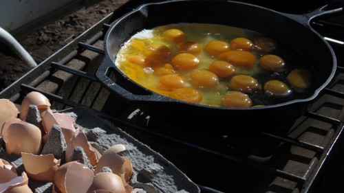 eggs in the skillet on a camp stove