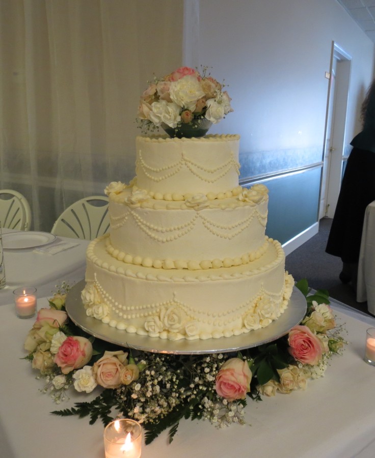 white wedding cake with fresh flowers